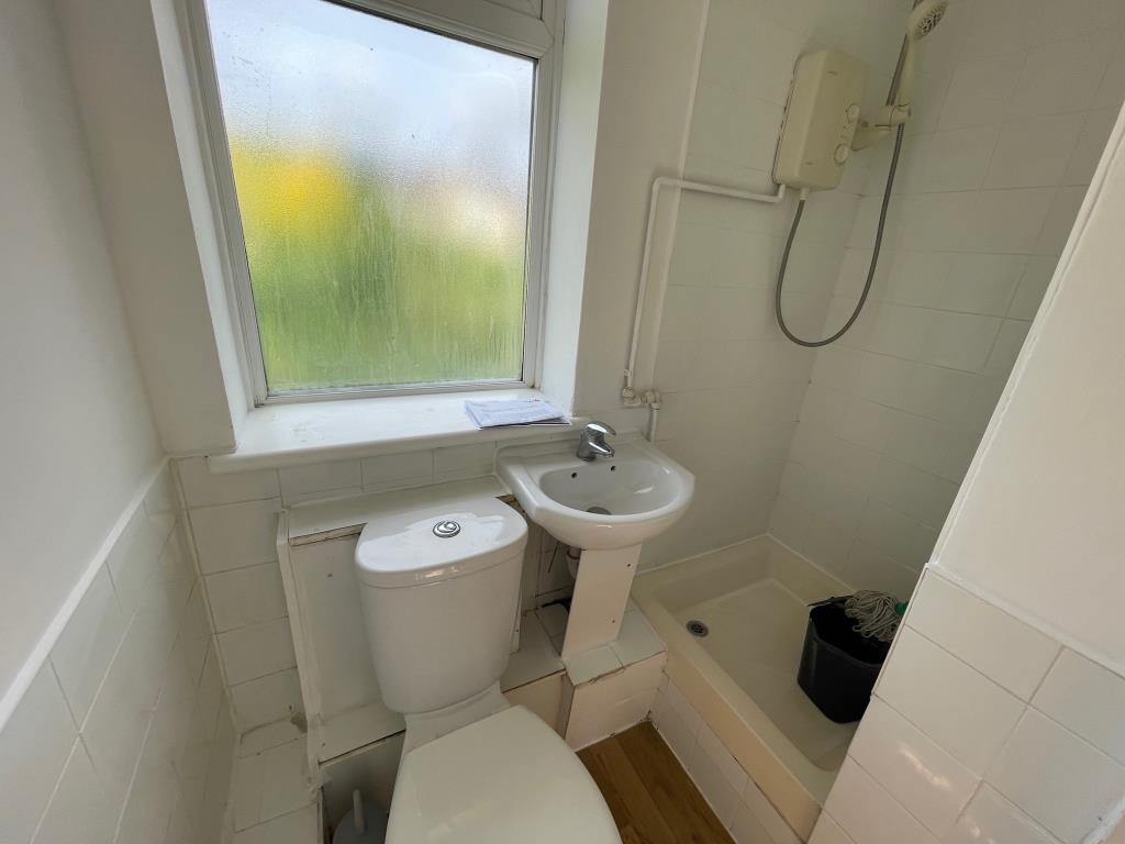 Lot: 154 - VACANT STUDIO FLAT IN NORTH LONDON - Shower room with WC and sink and Window to the rear